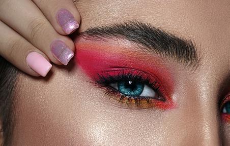 Close up photo of woman with pink and orange eyeshadow