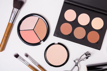 flat lay of makeup products and tools
