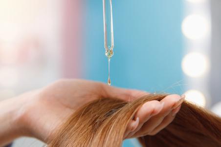 Hair oil being applied to hair