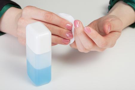 lady taking off nail polish with nail varnish remover
