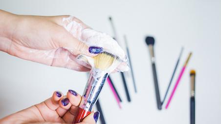 makeup brushes being cleaned
