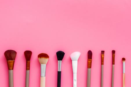 Makeup brushes on pink background