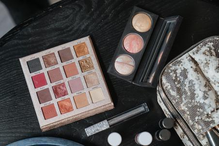 Makeup palette on black wooden backdrop