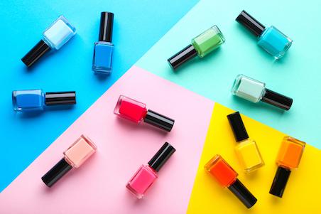 Nail polish bottles on colourful background