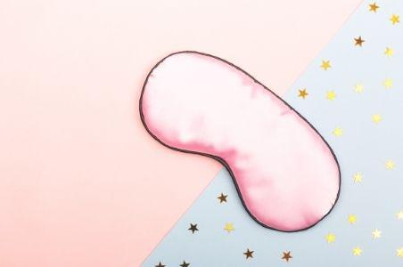 sleep mask on a pink and starry background