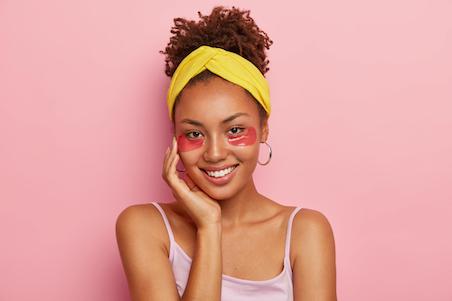 smiling woman with under eye patches