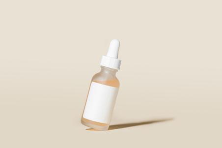 tilted cosmetics bottle on beige background