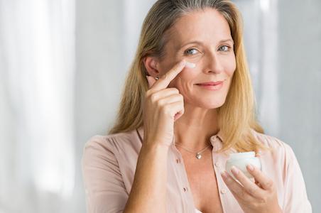 woman apply eye creams under the eyes