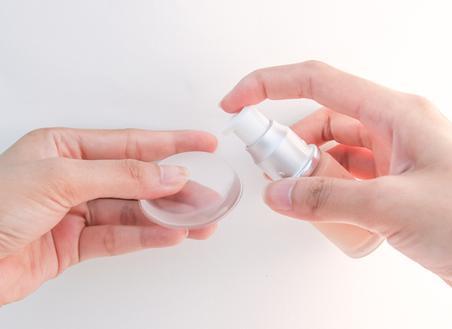 Woman applying foundation to a silicone beauty sponge