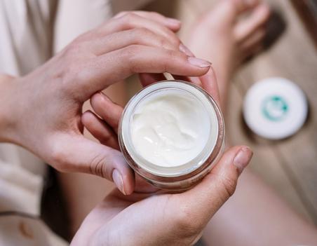Woman holding anti-ageing cream
