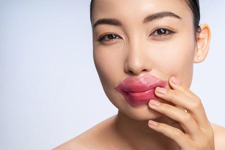 Woman using a lip mask
