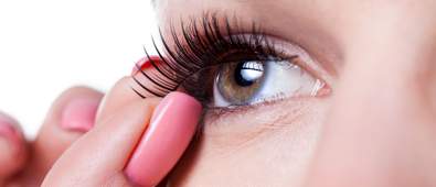 woman applying false lash