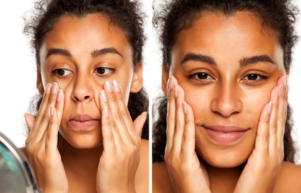 Woman massaging product into her cheeks