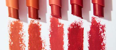 five lipsticks on white background