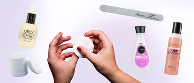 picture of someone's hands taking off nail polish with products around them