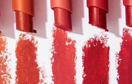 five lipsticks on white background