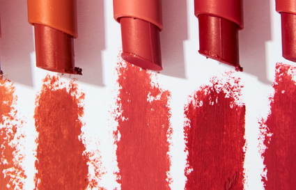 five lipsticks on white background