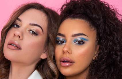 Two women looking at the camera with flawless makeup