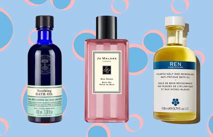 Three bottles of bath oils on a blue background with pink and blue bubbles