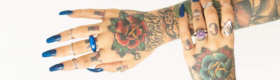 girl with tattooed hands and long blue nails
