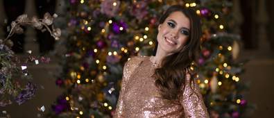 christmas makeup woman smiling in front of christmas tree