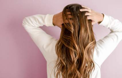 woman with hands behind her head