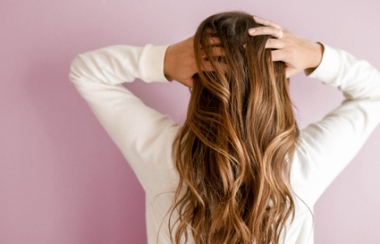 woman with hands behind her head