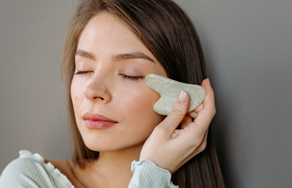 Woman using gua sha tool
