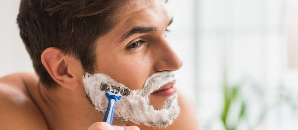 Man shaving in mirror
