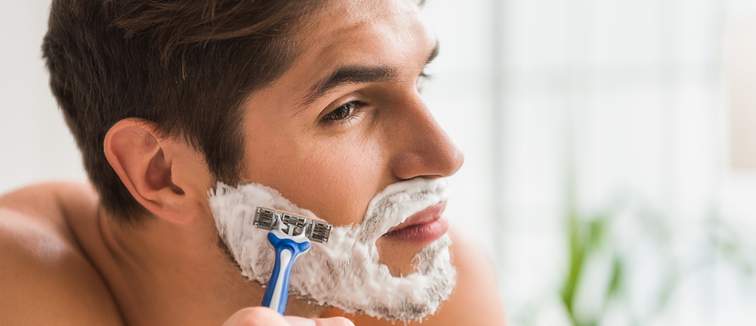 Man shaving in mirror
