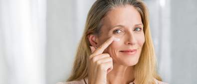 Mature woman applying face cream