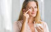 Mature woman applying face cream