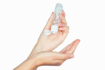 woman applying hand sanitiser
