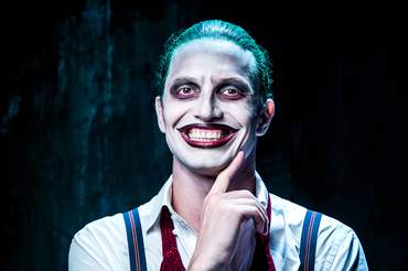man dressed as the joker smiling