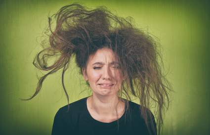 girl with crazy hair on green background