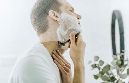 man shaving in mirror