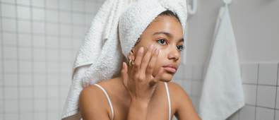 woman putting on face serum
