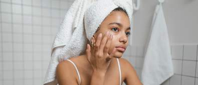 woman putting on face serum