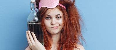 Woman with messy hair holding a bottle of water