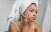 woman putting on face serum